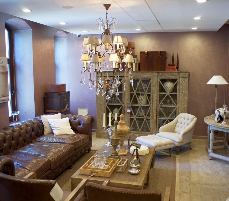 Chandelier Hanging in a room filled with furniture