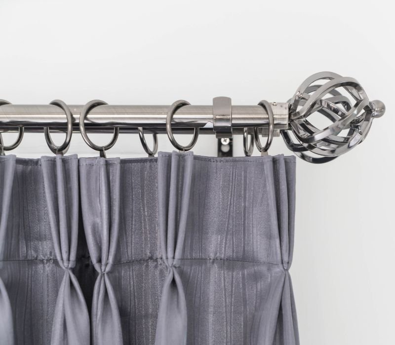 grey curtain hanging on silver rod