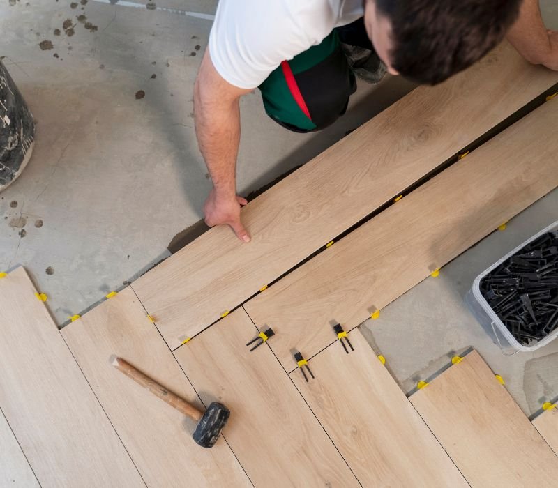 a mason balancing parquet flooring