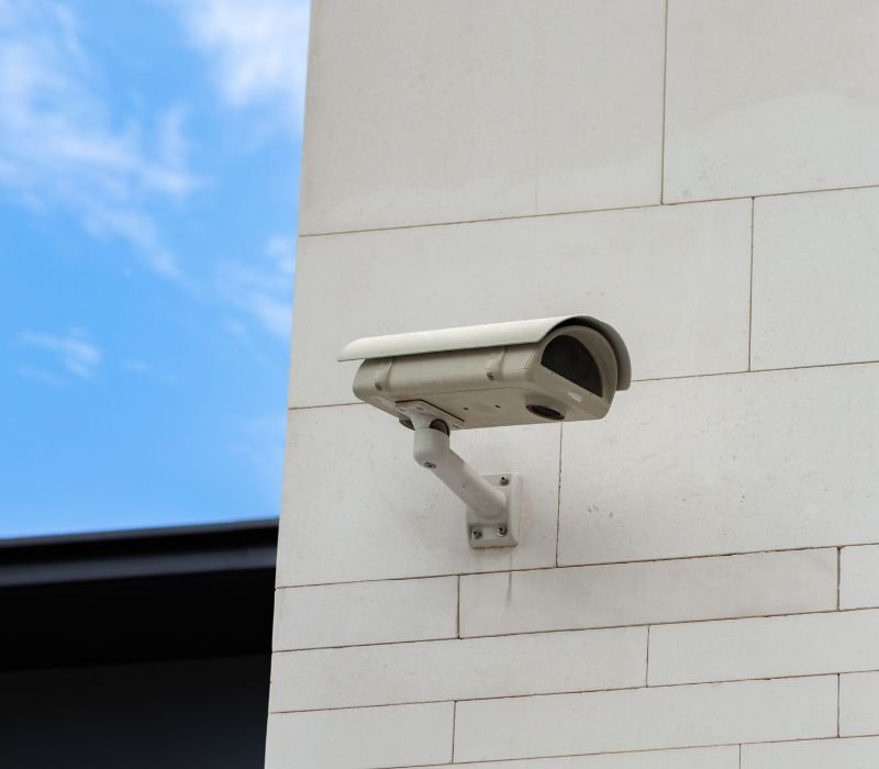 an outside white cctv security camera