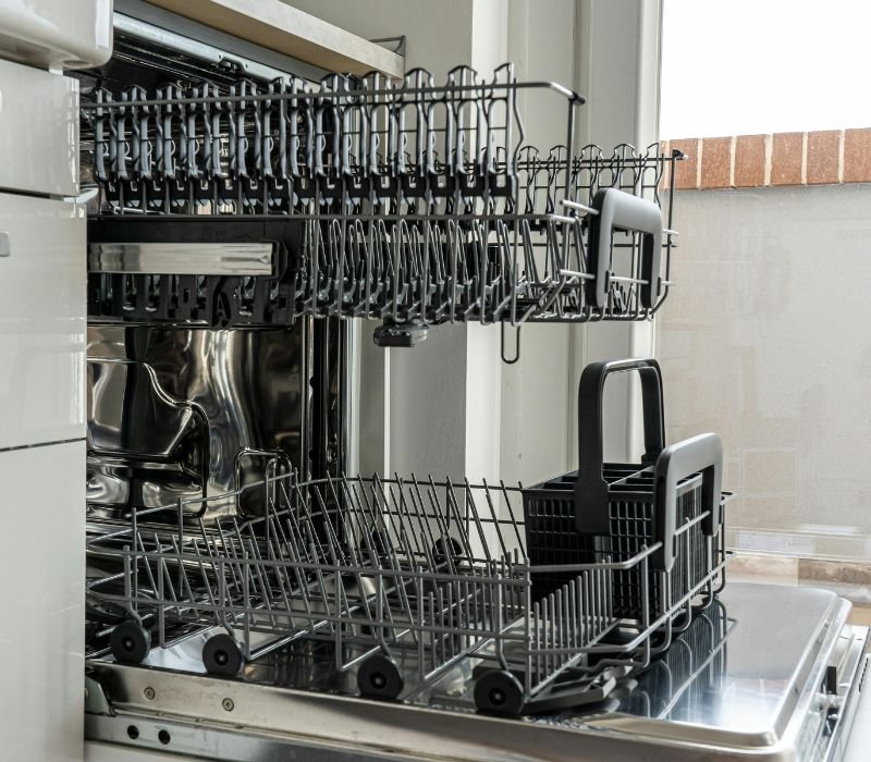 a closeup of opened empty dishwasher