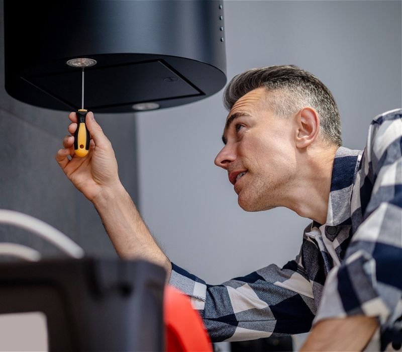 a man repairing light lamp with screw driver