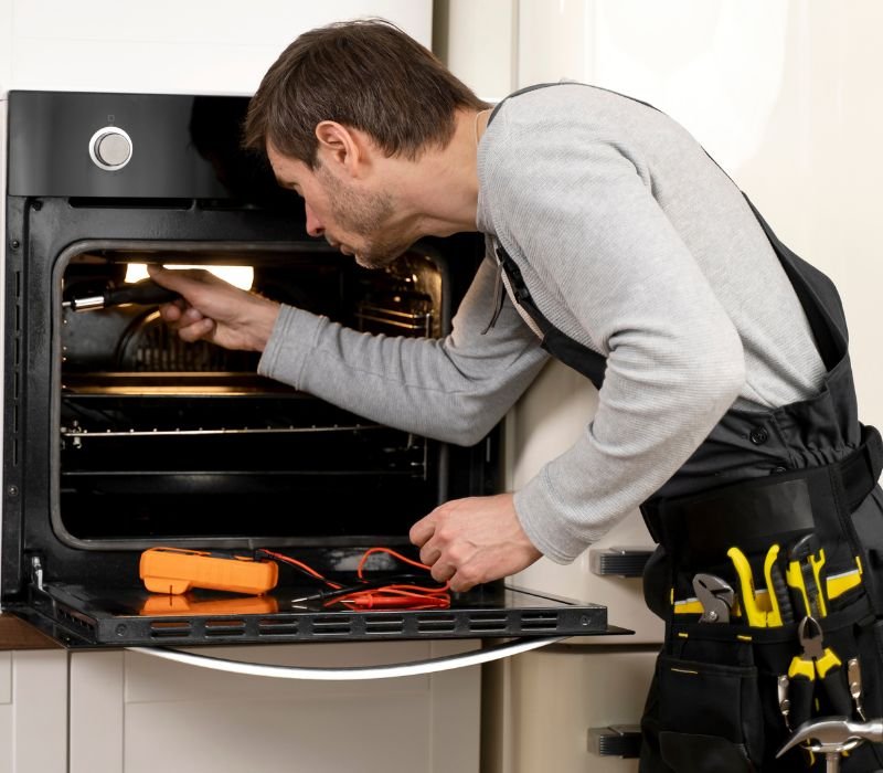 a boy is repairing microwave with tools