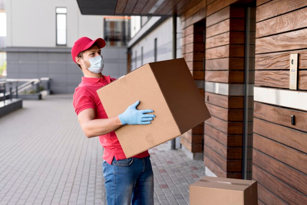 a boy standing holding a box